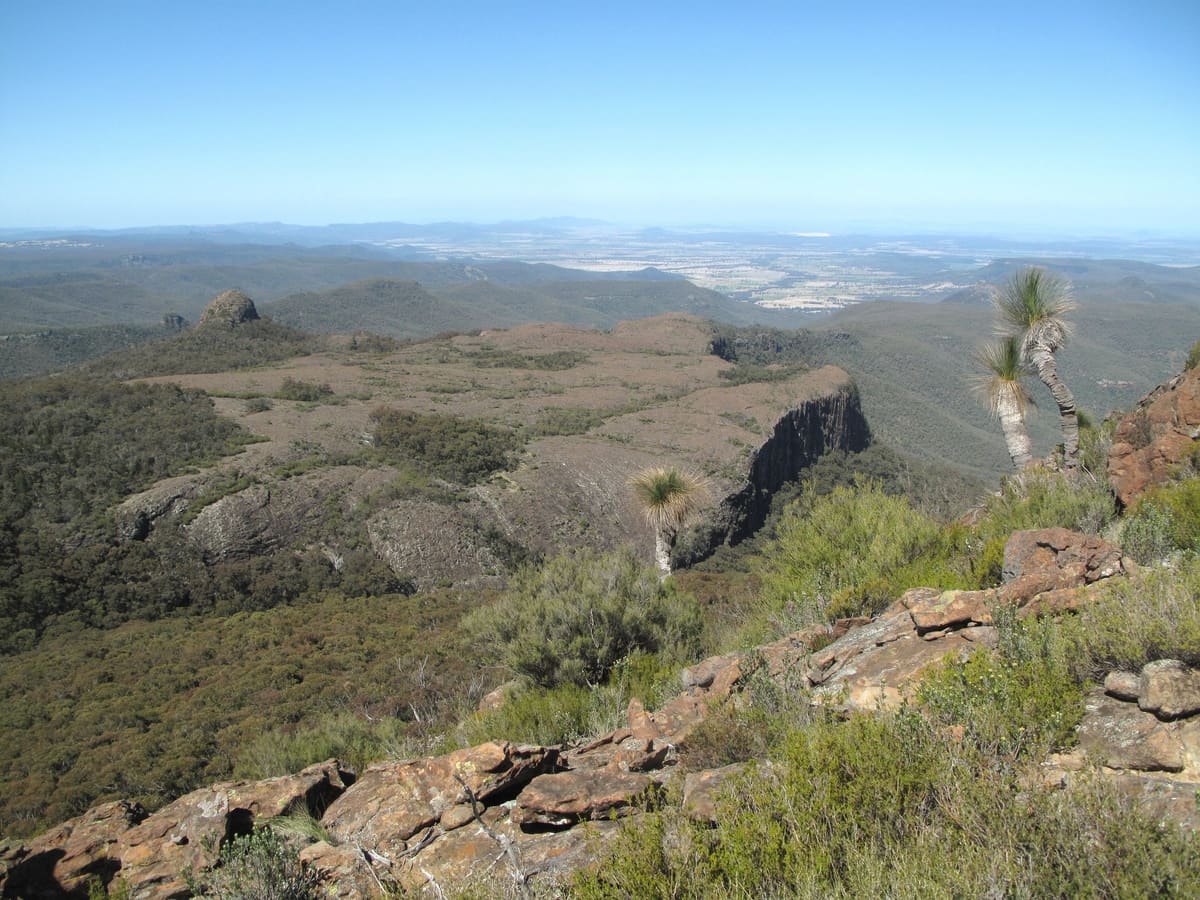 Rocky ridges and the Camels Hump lava flow above distant plains
