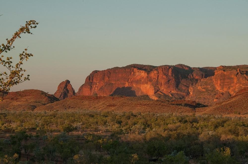 Sunset light washing over the striped sandstone domes of the Bungle Bungle Range in Purnululu National Park, East Kimberley