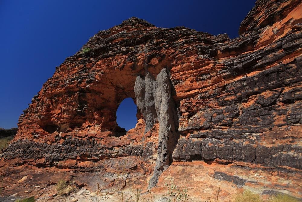The Window lookout in Purnululu National Park, a natural rock opening framing the banded domes of Piccaninny Creek beyond